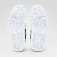 Bottom view of a pair of white Air Jordan 1 Low Golf shoes, showing the circular traction pattern and Nike Golf branding on the outsoles.