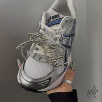 White and silver ASICS trainers with dainty lace shoelaces, silver bead bow lace charms and star sneaker accessories