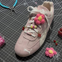 Pink Puma Speedcat trainers with dainty lace charms, flower lace accessories, cherry charms and personalised shoelace beads by MattB Customs