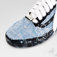 Close-up of Denim Bloom custom Vans Old Skool showcasing distressed denim, white flower artwork, pearl embellishments, fluffy white laces and hand-painted sole.