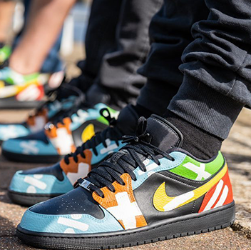 Group photo of 4 pairs of Ed Sheeran mathematics tour themed jordan 1 lows