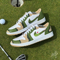 Custom Fairway Camo Jordan 1 Low Golf trainers on the putting green beside a golf hole and golf club