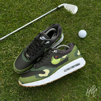 Nike Air Max 1 Fairway Camo custom golf trainers on putting green with golf club and ball