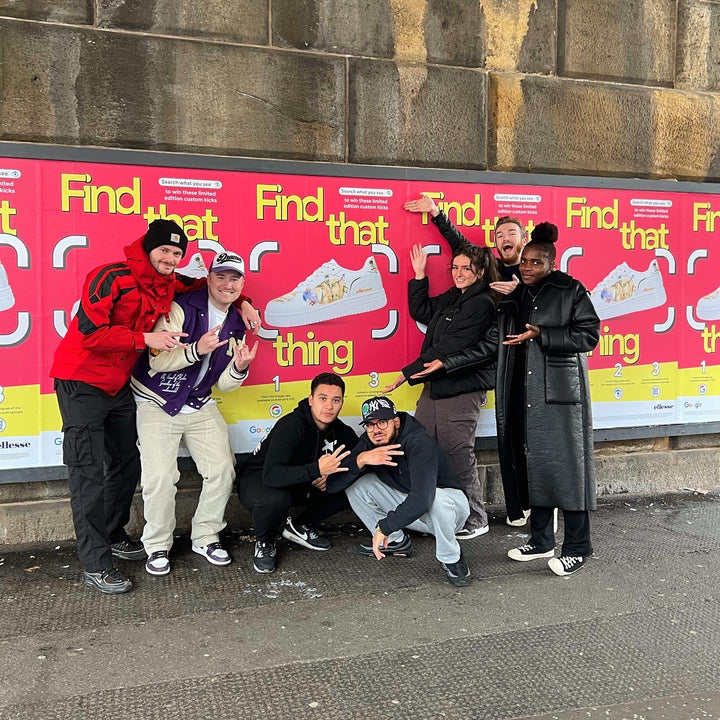 MattB Customs team in front of 'Find That Thing' billboard in Manchester featuring the custom ellesse shoe