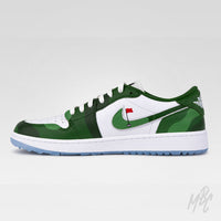 A low-top Nike sneaker in green and white, featuring a green camouflage pattern on the toe and heel, a white side panel with a green swoosh, a small red flag graphic on the swoosh, and a light blue outsole.