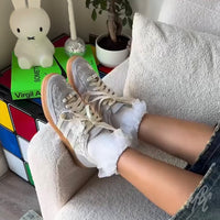 Lacey Flower custom Adidas Spezial trainers with floral lace detail worn in relaxed indoor setting