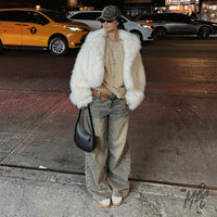 Model wearing Lacey Flower custom Adidas Spezial trainers styled with streetwear at night in city