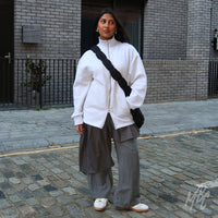 Model wearing Lacey Flower custom Adidas Spezial trainers in neutral tones styled for everyday streetwear