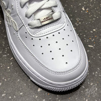 Close-up of white Air Force 1 toe box with custom Just Married lace lock and premium leather finish