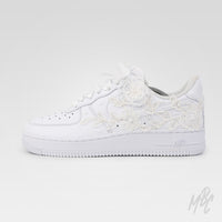 Side view of white Air Force 1 custom with lace floral overlays and custom date detail on heel