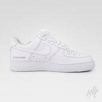 Studio image of white Nike Air Force 1 custom featuring lace material and pearl embellishments