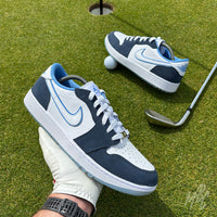Navy Suede Jordan 1 Low Golf custom golf shoe photographed on a putting green with golf ball and iron club