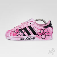 Outer side view of Pink Overgrown custom Adidas Superstar featuring hand-painted floral artwork, textured pink paint and Overgrown branding.