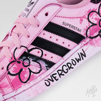 Close-up of Pink Overgrown custom Adidas Superstar featuring hand-painted pink flowers, textured paint details and black hand-drawn graphics.