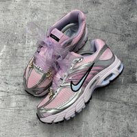 Pink Nike Moto 2 trainers styled with lilac organza ribbon laces, personalised lace tags and gold lace charms from the Lace Charm Pack