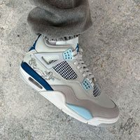 Renaissance custom Jordan 4 on foot showing hand painted angel artwork and blue midsole