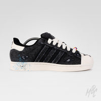 Inside view of Stardust Denim custom Adidas Superstar featuring distressed black denim, blue paint splatter detailing and hand-painted finish.
