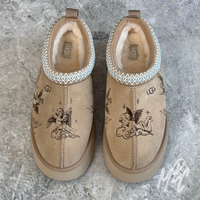 Custom engraved UGG Tazz II slippers featuring tattoo-inspired cherub illustrations etched directly into suede for a permanent finish