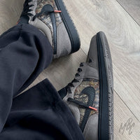 Woodland Camo Jordan 1 Low on foot side view with woodland camo panels and black swoosh