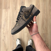 Woodland Camo Jordan 1 Low custom held in hand with brown suede overlays and black midsole