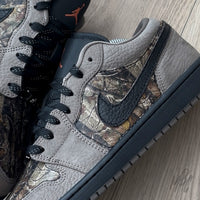 Woodland Camo Jordan 1 Low close up of camo side panel and textured black leather swoosh