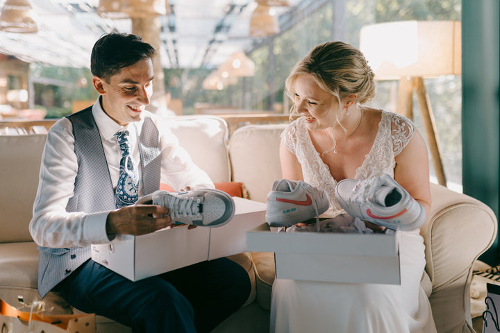Bride and groom opening their custom Nike sneakers at their wedding