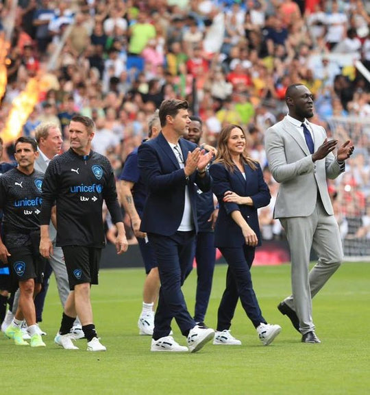 The World XI walking on the pitch with customs shoes