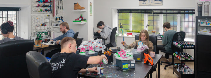 MattB Customs Workshop or office space with people working on trainer projects, surrounded by tools and materials.