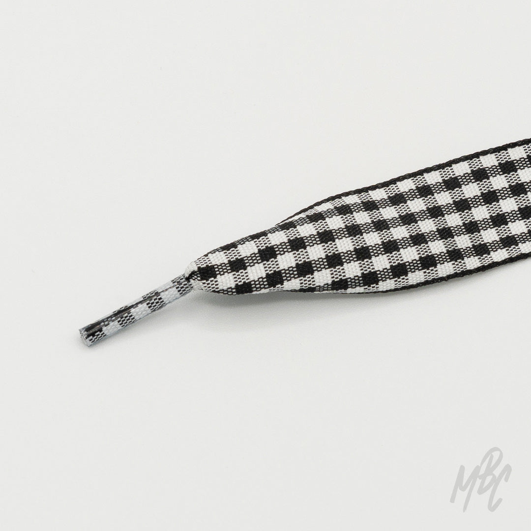 Black and white checkered sneaker laces featuring a woven square pattern for custom trainers and statement footwear