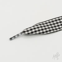 Black and white checkered sneaker laces featuring a woven square pattern for custom trainers and statement footwear
