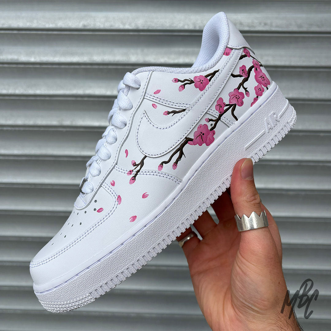 White Nike Air Force 1 with hand painted blossom tree across the outside of the trainer