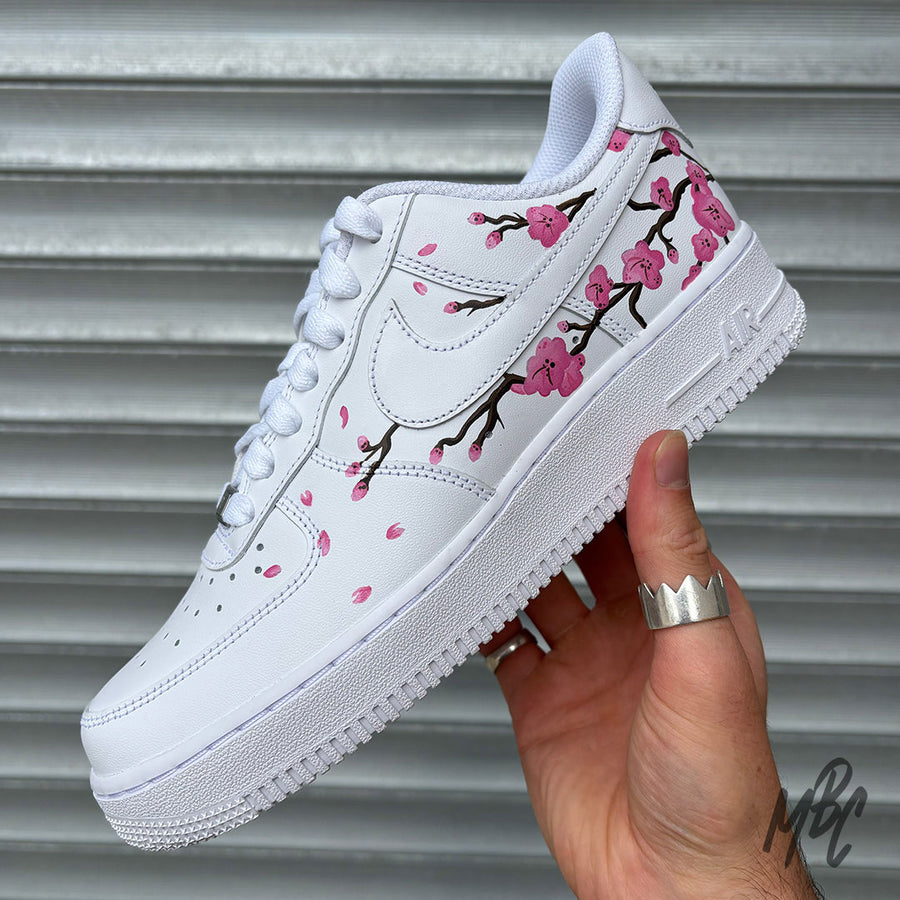 White Nike Air Force 1 with hand painted blossom tree across the outside of the trainer