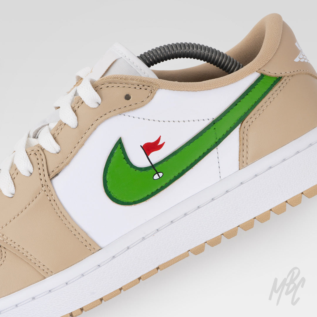 Close-up of Clean on the Green 2.0 Jordan 1 Low Golf sneaker featuring hand-painted green Swoosh with golf flag and hole artwork