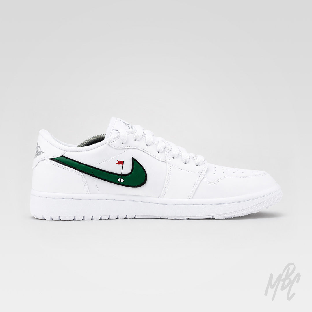 Opposite side profile of an all-white Air Jordan 1 Low Golf shoe with a green golf-themed Nike Swoosh, black outline, and red flag detail.