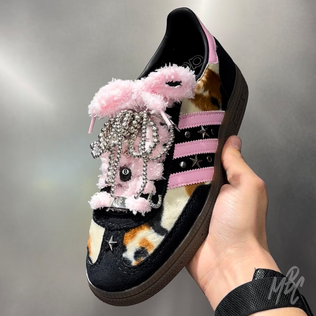 Custom Adidas Spezial trainers with pink fluffy laces, silver bow charms, ball chain bows and decorative lace accessories