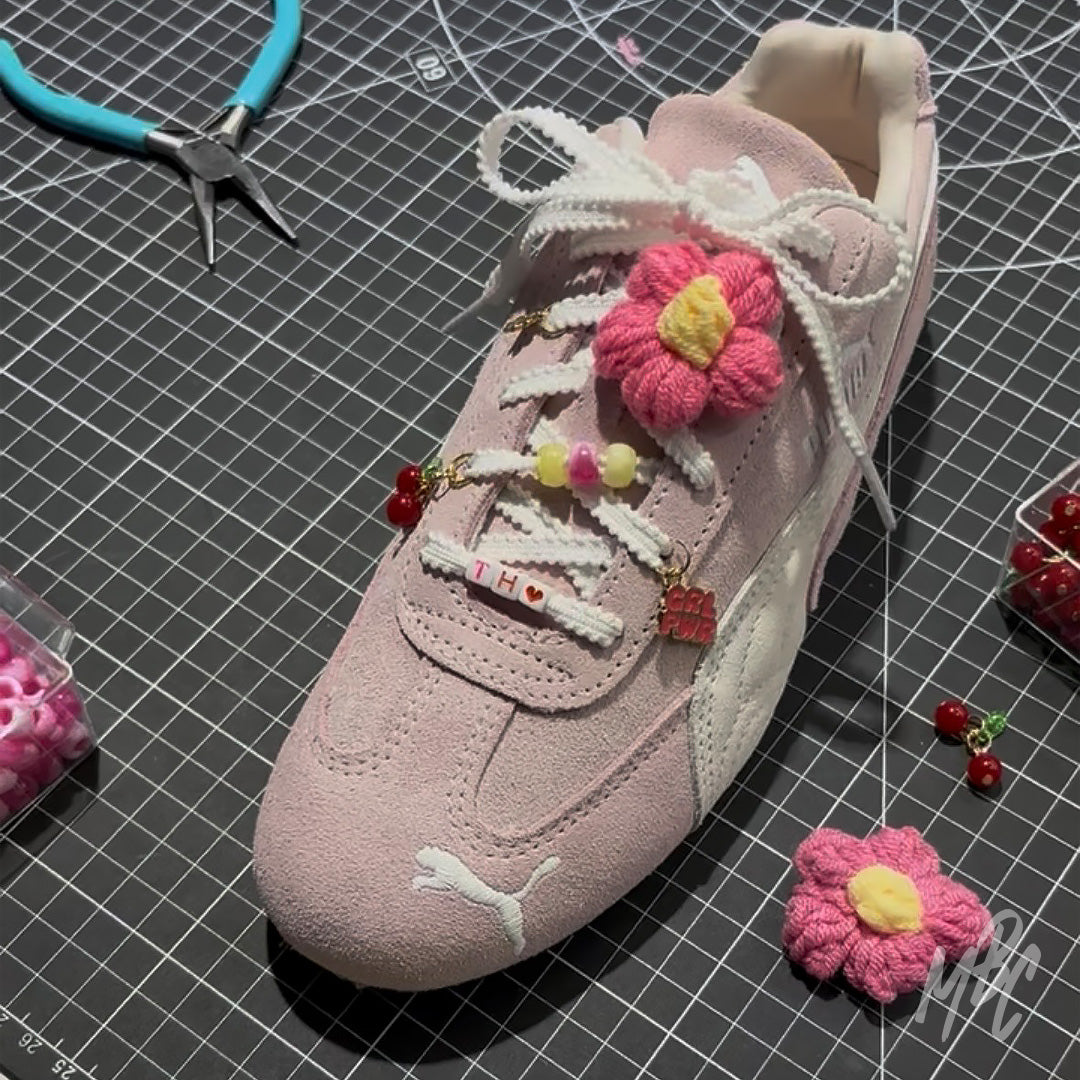 Pink Puma Speedcat trainers with dainty lace charms, flower lace accessories, cherry charms and personalised shoelace beads by MattB Customs