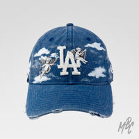 Denim Heaven New Era NY custom cap in blue denim with cherub angel illustrations, hand painted clouds and distressed brim