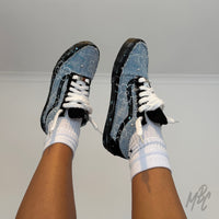 On-foot view of custom Denim Bloom Vans Old Skool sneakers with fluffy white laces, distressed denim panels and floral hand-painted design.