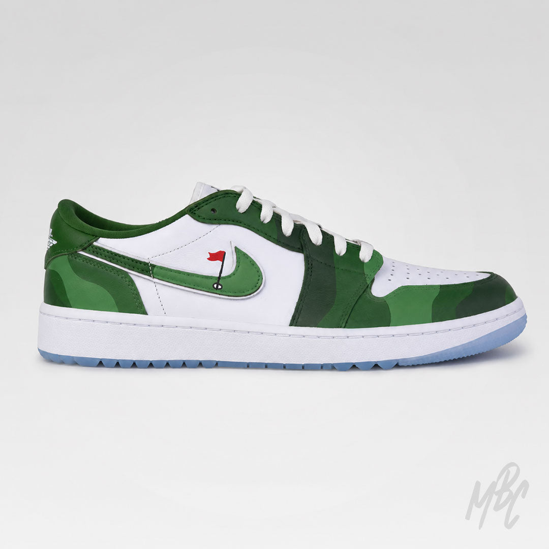 A low-top Nike sneaker in green and white, featuring a green camouflage pattern on the toe and heel, a white leather side panel with a green Swoosh, white laces, and a light blue outsole.