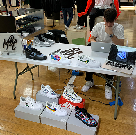 hand paiting nike trainers at a Harvey Nichols, Manchester store