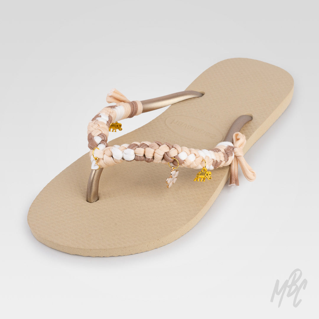 Sunwoven Mocha custom Havaianas featuring handcrafted braided beige, brown and white straps with gold charms and floral detailing.