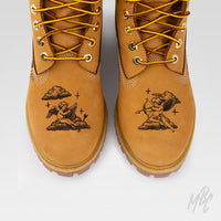 Hand-engraved Timberland 6 Inch boots in tan suede featuring tattoo-inspired cherub artwork etched into the toe box