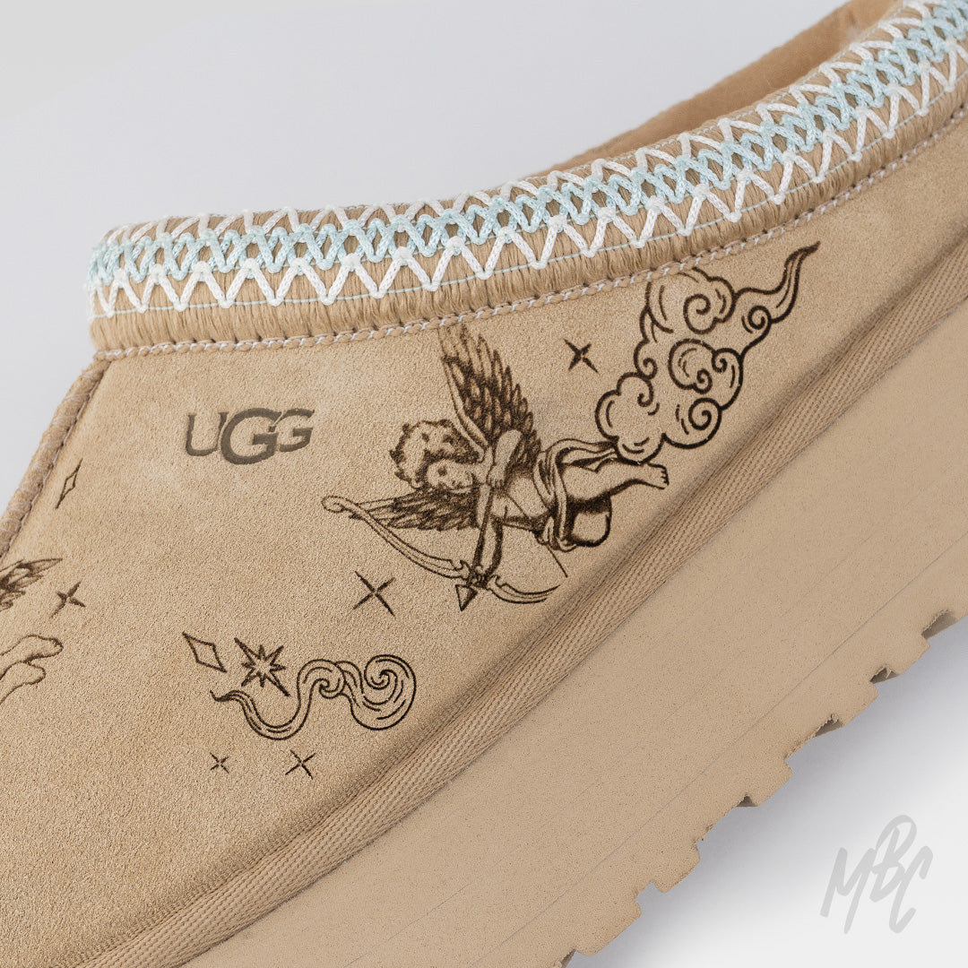 Close-up of tattoo-inspired cherub artwork engraved into suede on the Heaven Etched UGG Tazz II custom