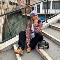 Flaming Dragon custom Timberland boots with hand-engraved dragon artwork worn by fashion influencer in Venice canal street setting