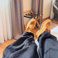 On-foot view of Flaming Dragon custom Timberland boots featuring detailed engraved dragon design on tan leather