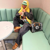 Flaming Dragon custom Timberland boots styled by fashion influencer with streetwear outfit in café setting