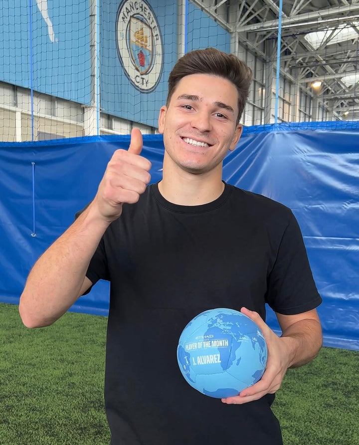 Alvarez holding his Manchester City Player of the Month custom football