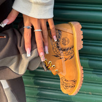 Close-up of Flaming Dragon Timberland boots showing hand-engraved dragon artwork