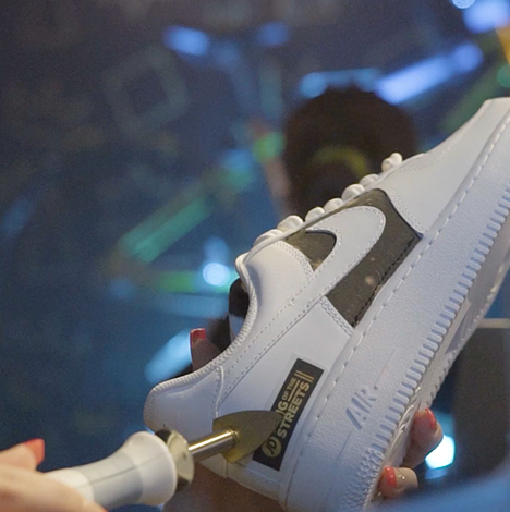 JD street party logo being ironed on Air Force 1 at their pop up event