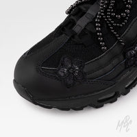Close-up of Midnight Veil custom Nike Air Max 95 featuring black floral embroidery, satin ribbon laces and black beaded bow charm.